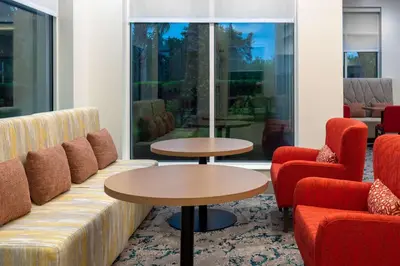a lobby with a couch and two tables and chairs at Hilton Garden Inn Orlando International Drive North in Orlando