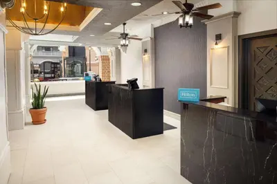 a lobby with a hair salon with black counter tops at Embassy Suites by Hilton Orlando North in Orlando