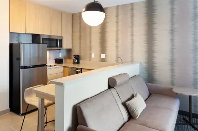 a kitchen with a couch and a table in a room at Residence Inn by Marriott Orlando at Millenia in Orlando