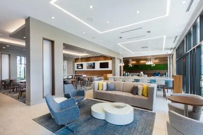 a lobby with a couch and chairs and a table at Residence Inn by Marriott Orlando at Millenia in Orlando