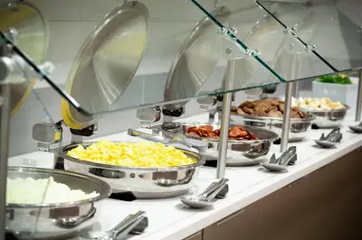 a buffet line with many different types of food at SpringHill Suites by Marriott Orlando at Millenia in Orlando