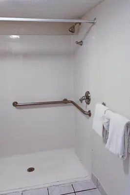 a bathroom with a shower with a towel at Orlando Inn International Drive Area in Orlando