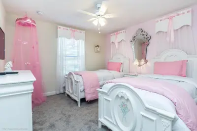 a pink and white bedroom with two beds and a dresser at Romeo Circle #239854 Townhouse in Kissimmee