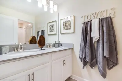 a bathroom with a sink and a mirror at Romeo Circle #239854 Townhouse in Kissimmee