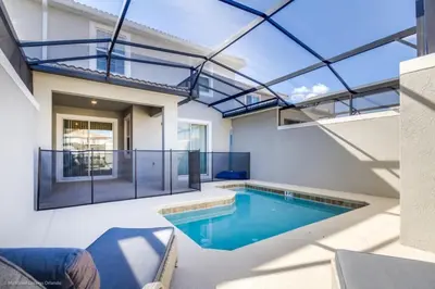 a swimming pool in a house with a glass ceiling at Romeo Circle #239854 Townhouse in Kissimmee