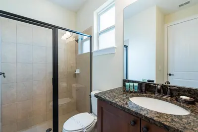 a bathroom with a sink and a shower and a toilet at Disney Dreams Luxury Home with Private Water Park in Orlando