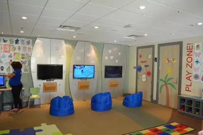 a woman standing at a desk in a room with surfboards at Disney Dreams Luxury Home with Private Water Park in Orlando