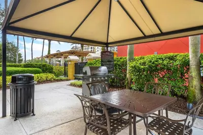 a table and chairs under a large umbrella at Hilton Grand Vacations Club Tuscany Village Orlando in Orlando
