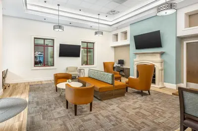 a waiting room with furniture and a fireplace at Hilton Grand Vacations Club Tuscany Village Orlando in Orlando