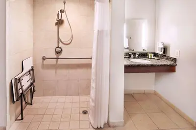 a bathroom with a shower and a sink at Hilton Grand Vacations Club Tuscany Village Orlando in Orlando