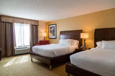 a hotel room with two beds and a window at Hilton Garden Inn Orlando East - UCF Area in Orlando