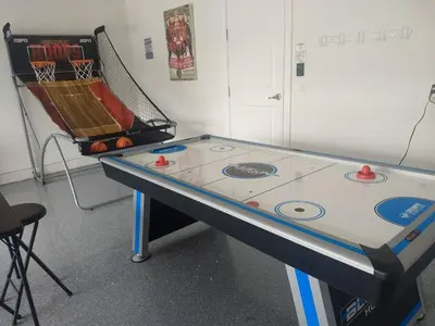 a ping pong table in a room with a ping pong ball at Luxury Dreams Disney Home with Private Pool and Spa in Orlando