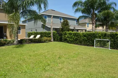 a yard with a soccer ball in front of a house at Luxury Dreams Disney Home with Private Pool and Spa in Orlando