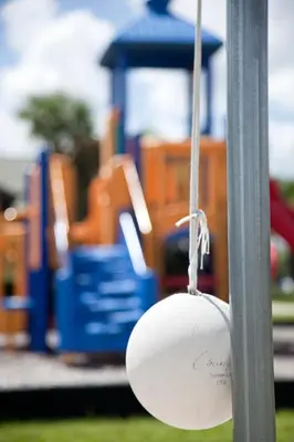 a ball hanging from a pole in front of a playground at DISNEY area Luxurious House-Private Pool in Kissimmee