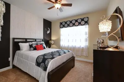 a bedroom with a bed and a ceiling fan at DISNEY area Luxurious House-Private Pool in Kissimmee
