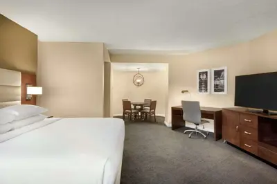 a hotel room with a bed and a desk with a television at DoubleTree by Hilton Orlando Downtown in Orlando