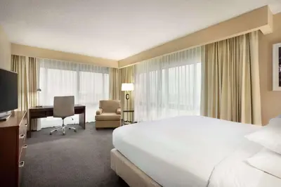 a hotel room with a large bed and a desk at DoubleTree by Hilton Orlando Downtown in Orlando