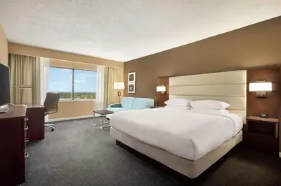 a hotel room with a large bed and a desk at DoubleTree by Hilton Orlando Downtown in Orlando