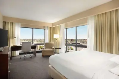 a hotel room with a bed and a desk with a computer at DoubleTree by Hilton Orlando Downtown in Orlando