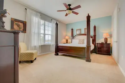 a bedroom with a bed and a ceiling fan at Gorgeous 1st-Floor, End Unit Condo w LAKEVIEW in Orlando