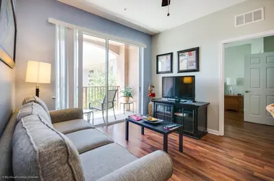 a living room with a couch and a tv at Beautiful PET FRIENDLY Condo Near Pool in Orlando