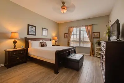 a bedroom with a large bed and a window at Lakeview Executive Penthouse in Orlando