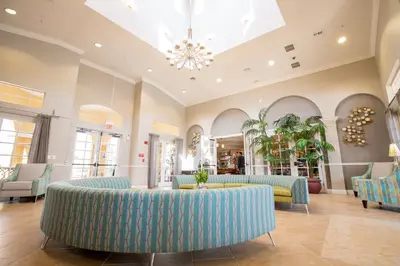 a lobby with blue couches and a chandelier at Lakeview Executive Penthouse in Orlando