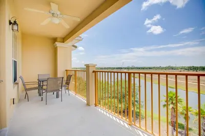 a patio with a table and chairs on a balcony at Top-Floor Luxurious LAKEVIEW Condo in Orlando