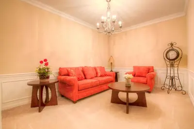 a living room with a red couch and two tables at Lovely Third-Floor Vista Cay Resort Condo in Orlando