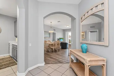 a living room with a table and a dining room at Penthouse Paradise in Orlando
