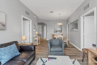 a living room with a couch and a chair at Penthouse Paradise in Orlando