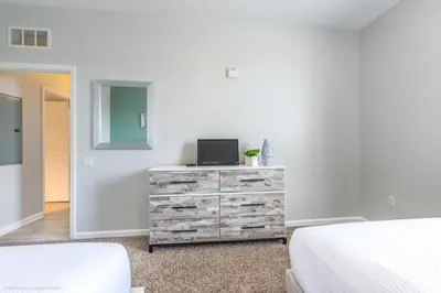 a bedroom with a dresser with a laptop on it at Stunning Top-Floor Condo, next to Clubhouse in Orlando