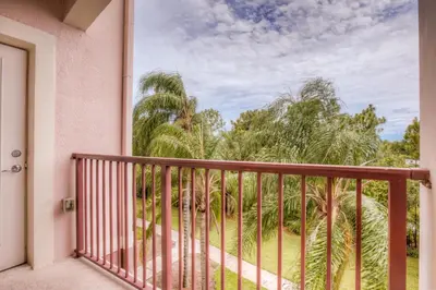a balcony with a view of palm trees at Vista Cay Condo w FREE Resort Access, near Disney in Orlando