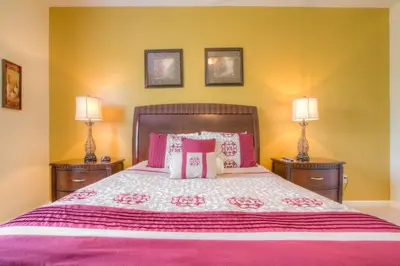 a bedroom with a large bed with two night stands at Lofty Lodge in Orlando