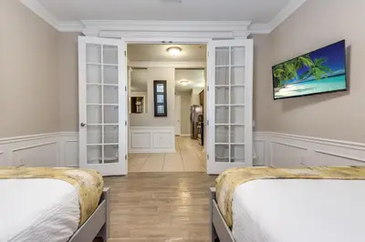 a bedroom with two beds and a hallway at Lovely Condo w FREE Access to Resort Amenities in Orlando