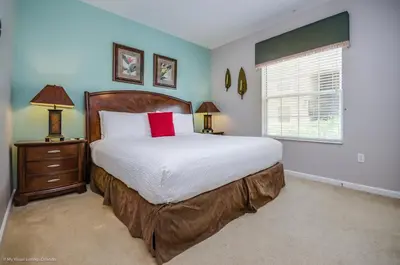 a bedroom with a large bed and a window at LAKEVIEW Condo at Vista Cay Resort in Orlando
