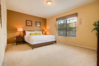 a bedroom with a bed and a window at Stylish Condo at Vista Cay Resort Minutes to WDW in Orlando