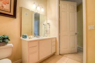 a bathroom with a sink and a mirror at Stylish Condo at Vista Cay Resort Minutes to WDW in Orlando