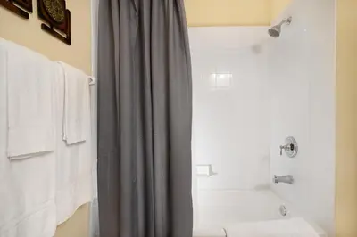 a bathroom with a shower curtain and a tub at Beautiful Condo at Vista Cay Resort Near WDW in Orlando