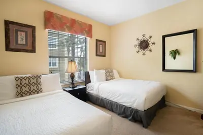 a bedroom with two beds and a window at Beautiful Condo at Vista Cay Resort Near WDW in Orlando