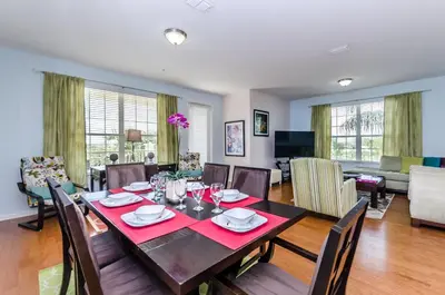 a dining room and living room with a table and chairs at Treasure Palace in Orlando