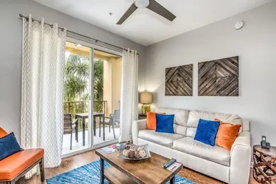 a living room with a couch and a table at Newly Updated Condo w Scenic Resort View in Orlando
