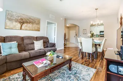 a living room with a couch and a table at Stylish Vista Cay Condo, near Orlando attractions in Orlando