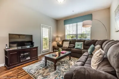 a living room with a couch and a tv at Stylish Vista Cay Condo, near Orlando attractions in Orlando