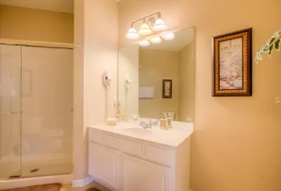 a bathroom with a sink and a shower and a mirror at Lovely Vista Cay Resort Condo, Near ClubhousePool in Orlando