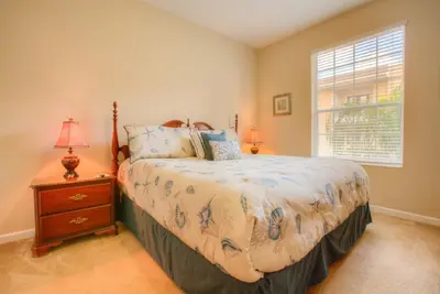 a bedroom with a bed and a nightstand and a window at Lovely Vista Cay Resort Condo, Near ClubhousePool in Orlando