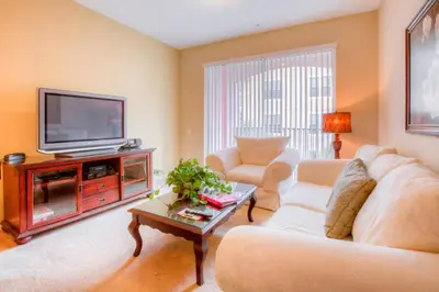 a living room with a couch and a tv at Lovely Vista Cay Resort Condo, Near ClubhousePool in Orlando