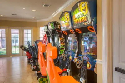 a row of video game machines in a room at Majestic Holiday in Orlando