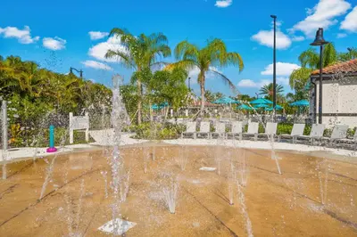a fountain in a park with palm trees at Luxurious Condo wPrivate Balcony AMAZING View in Orlando