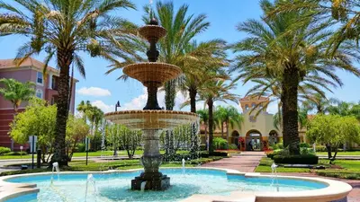 a fountain in a park with palm trees at Gorgeous Vista Cay Condo, next to Resort Clubhouse in Orlando